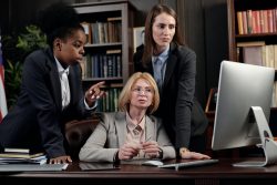 Legal professionals looking at computer monitor