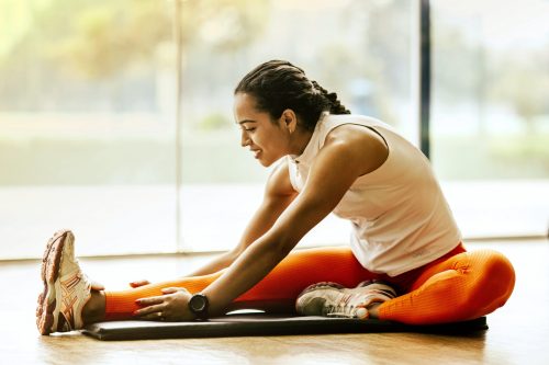 Young woman stretching legs