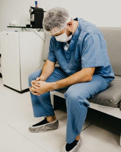 medical professional looking down at hands